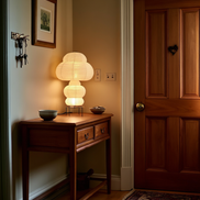 The Kumo tiered lamp on a hallway console with keys and a ceramic dish