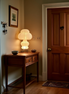 The Kumo tiered lamp on a hallway console with keys and a ceramic dish