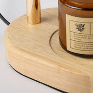 Close-up of the Ember lamp solid wood base holding a jar candle