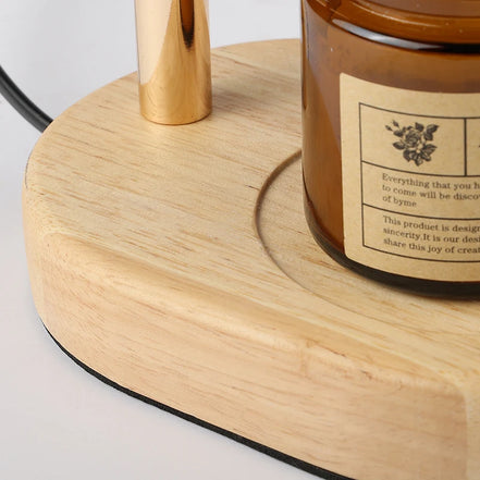 Close-up of the Ember lamp solid wood base holding a jar candle