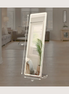 Full-length LED mirror standing in a neutral living room