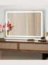 LED vanity mirror on a walnut console with warm border light